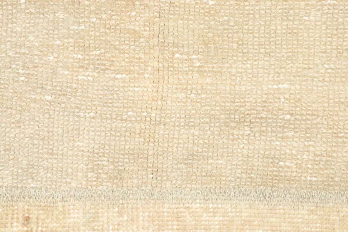 Detailed view of the low wool pile and the hand-knotted texture of the rug.