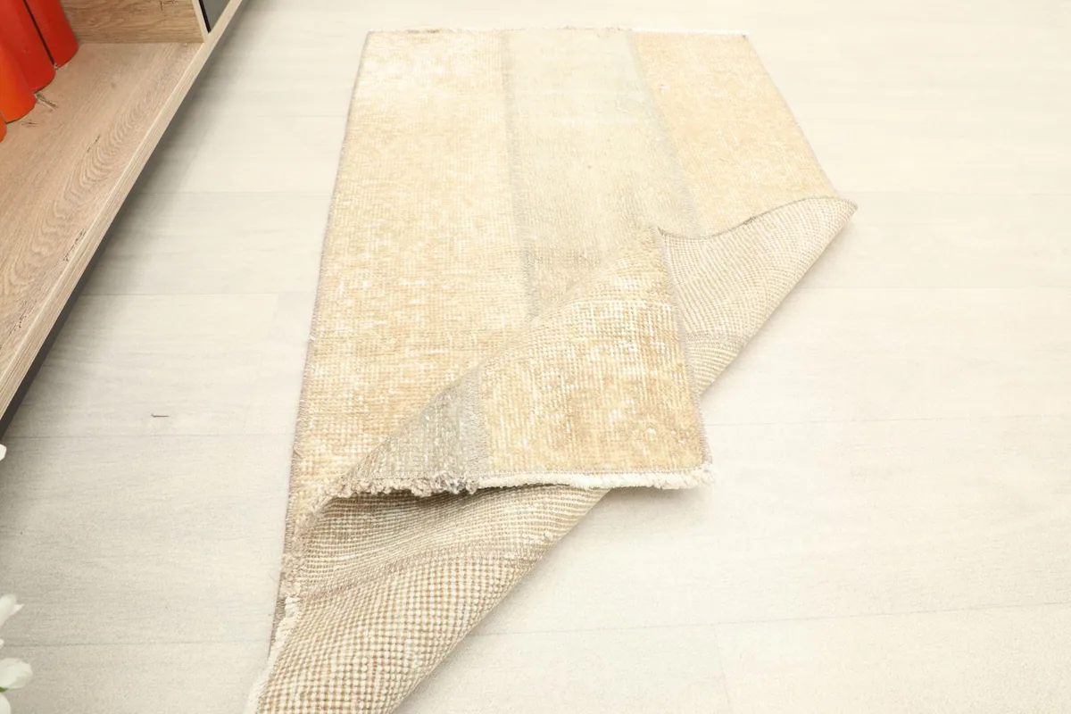 The rug folded to show its flexibility and the thickness of the wool pile.