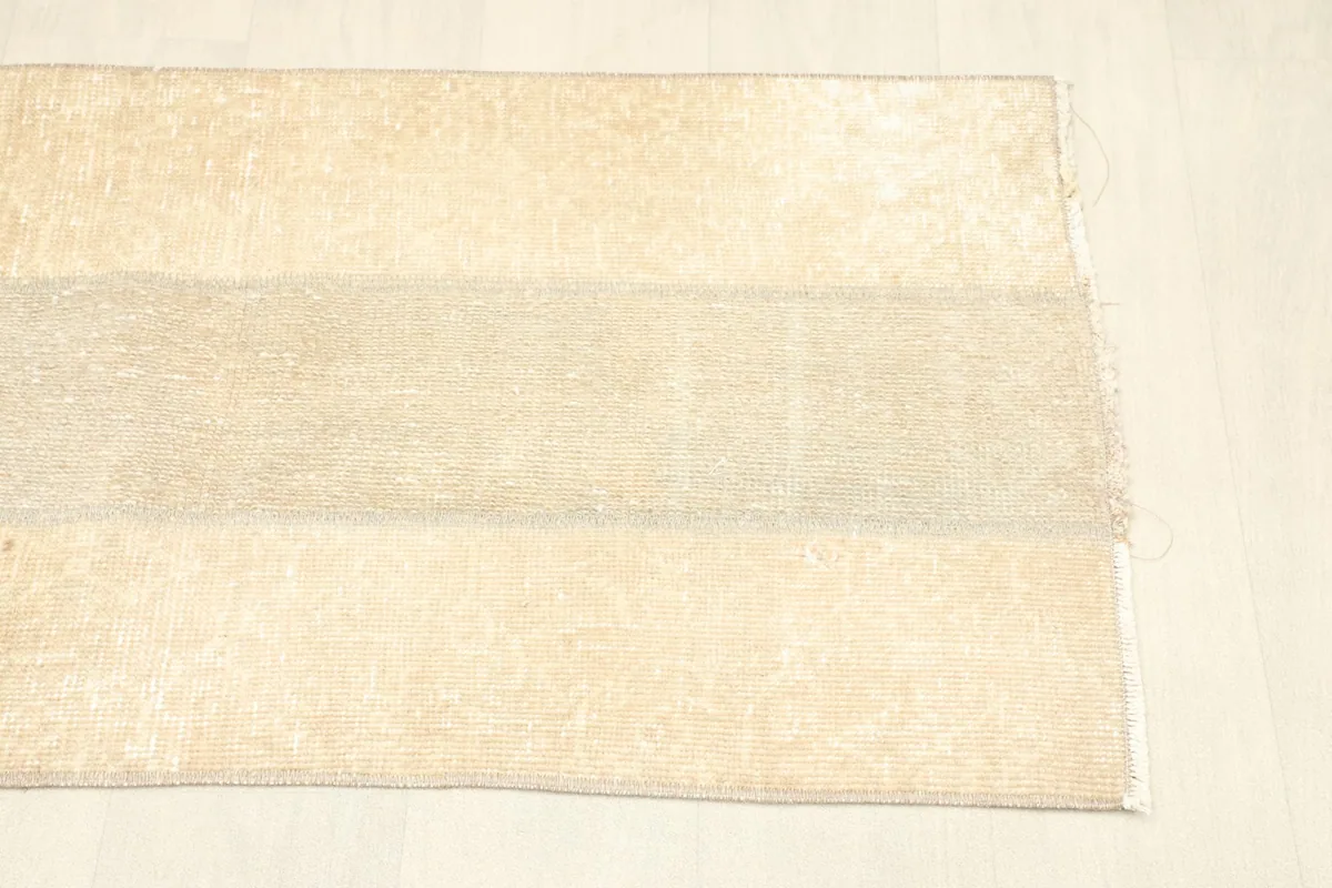Overhead perspective of the rug, showcasing its rectangular shape and faded appearance.