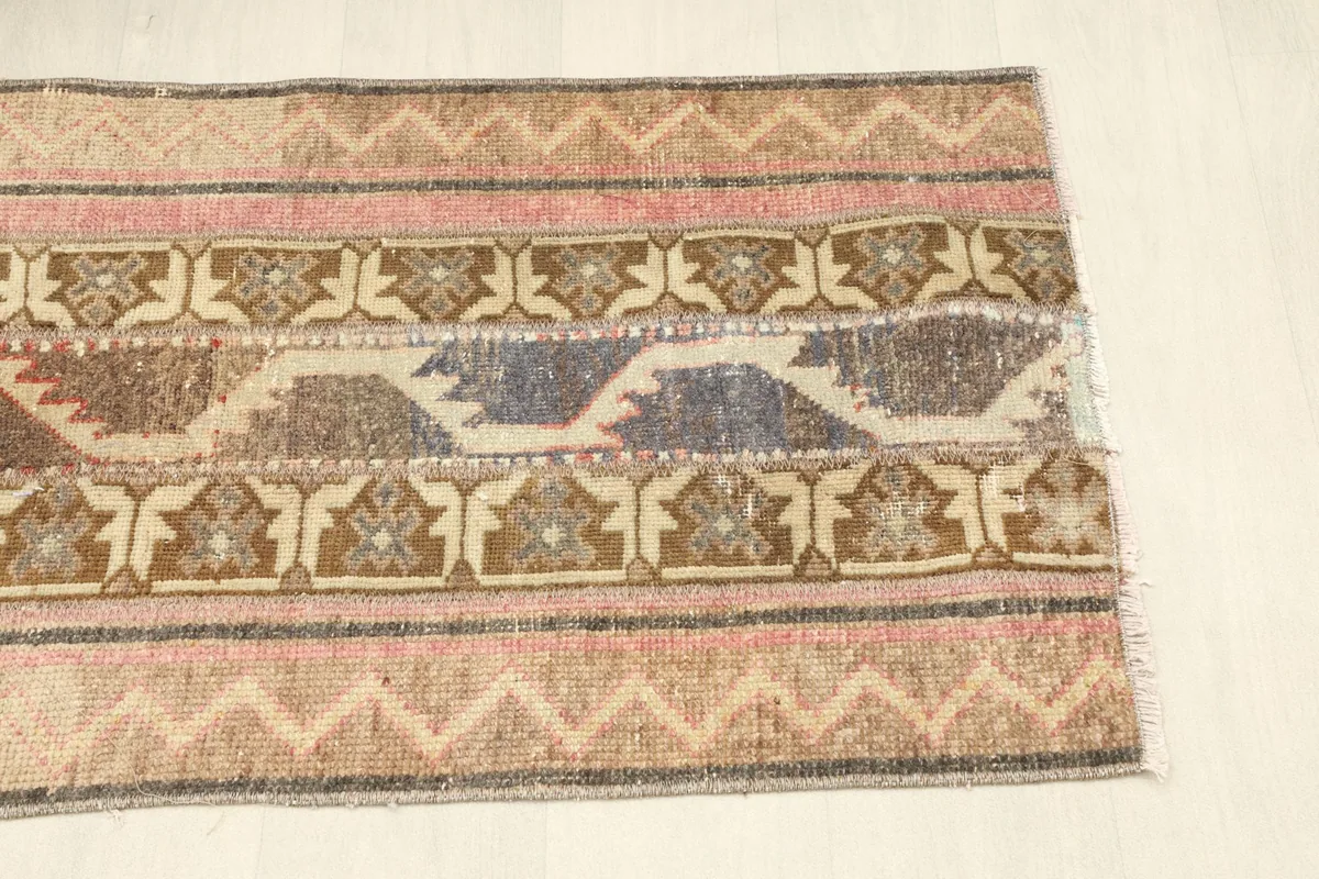 Detail of the opposite end of the rug, showing consistent striped patterns and visible fringe.