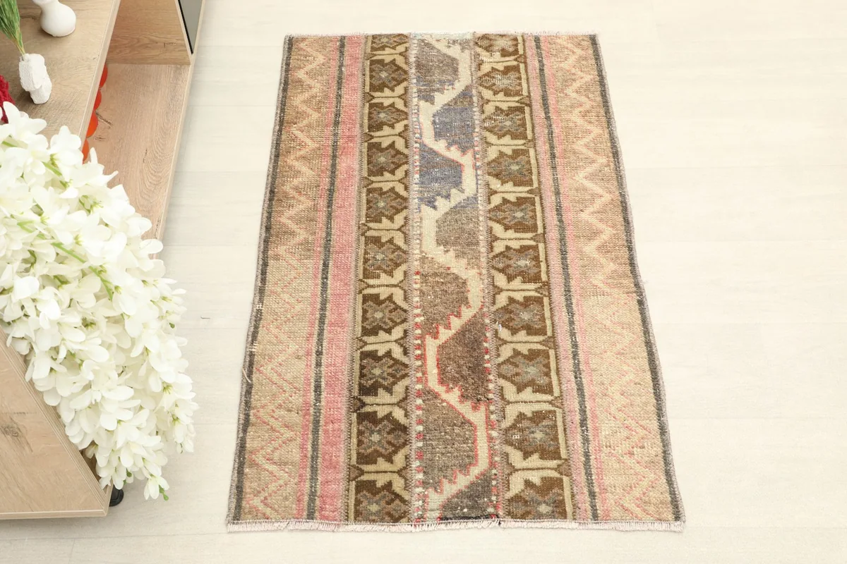Overhead view of the vintage Anatolian rug, highlighting its striped geometric patterns and color variations.