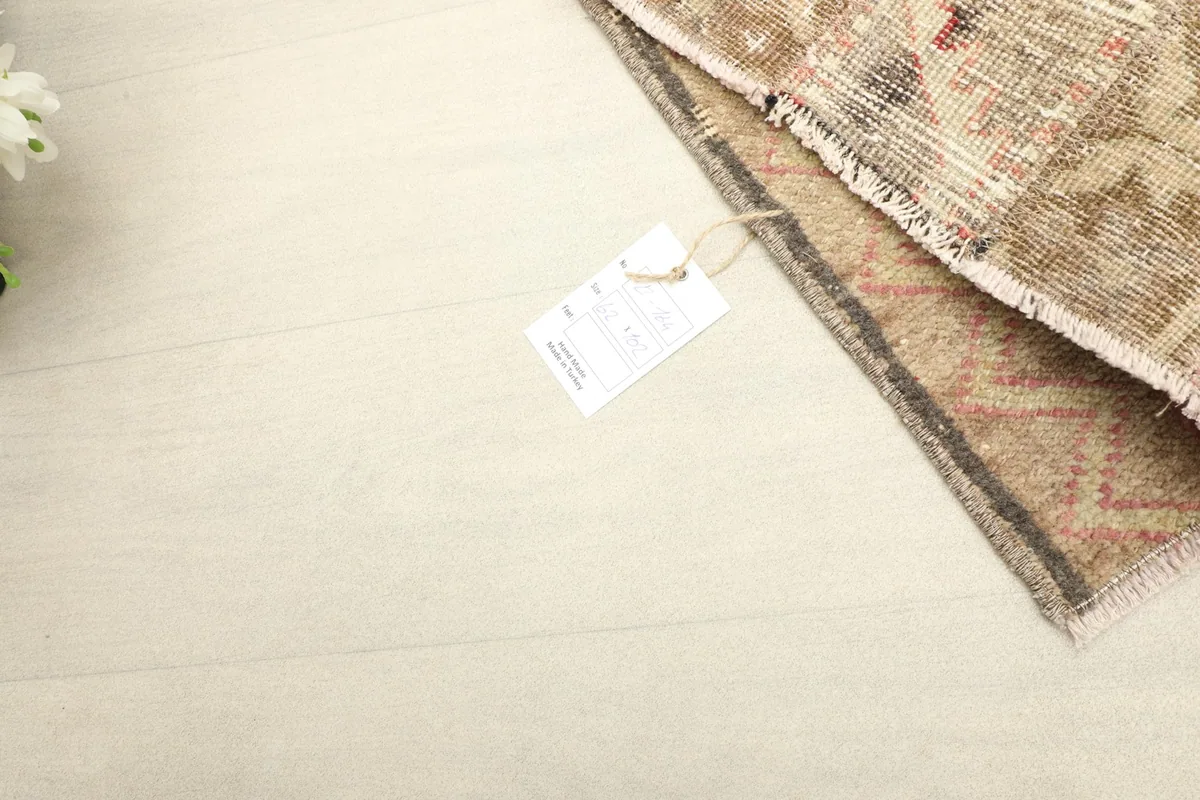 Rug tag visible on the reverse side of the rug, indicating its origin and materials.
