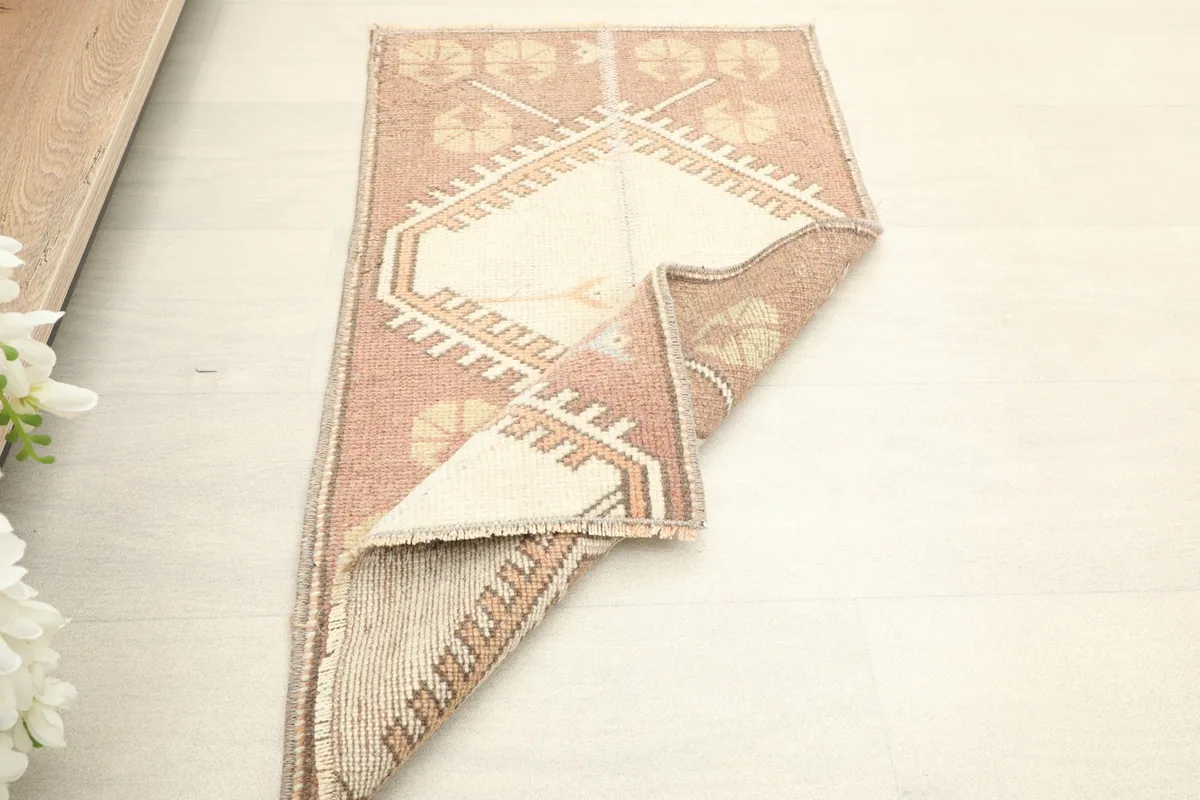 The vintage rug folded to show its flexibility and the texture of the wool pile.