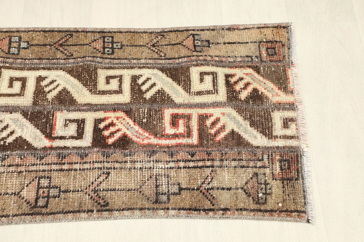 View of the opposite end of the rug, showcasing the border details and fringe.