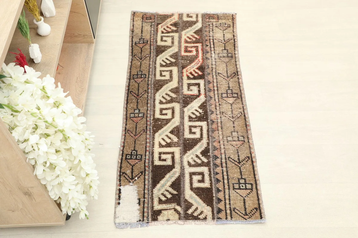 Overhead view of the hand-knotted vintage rug, highlighting its full length and tribal design.