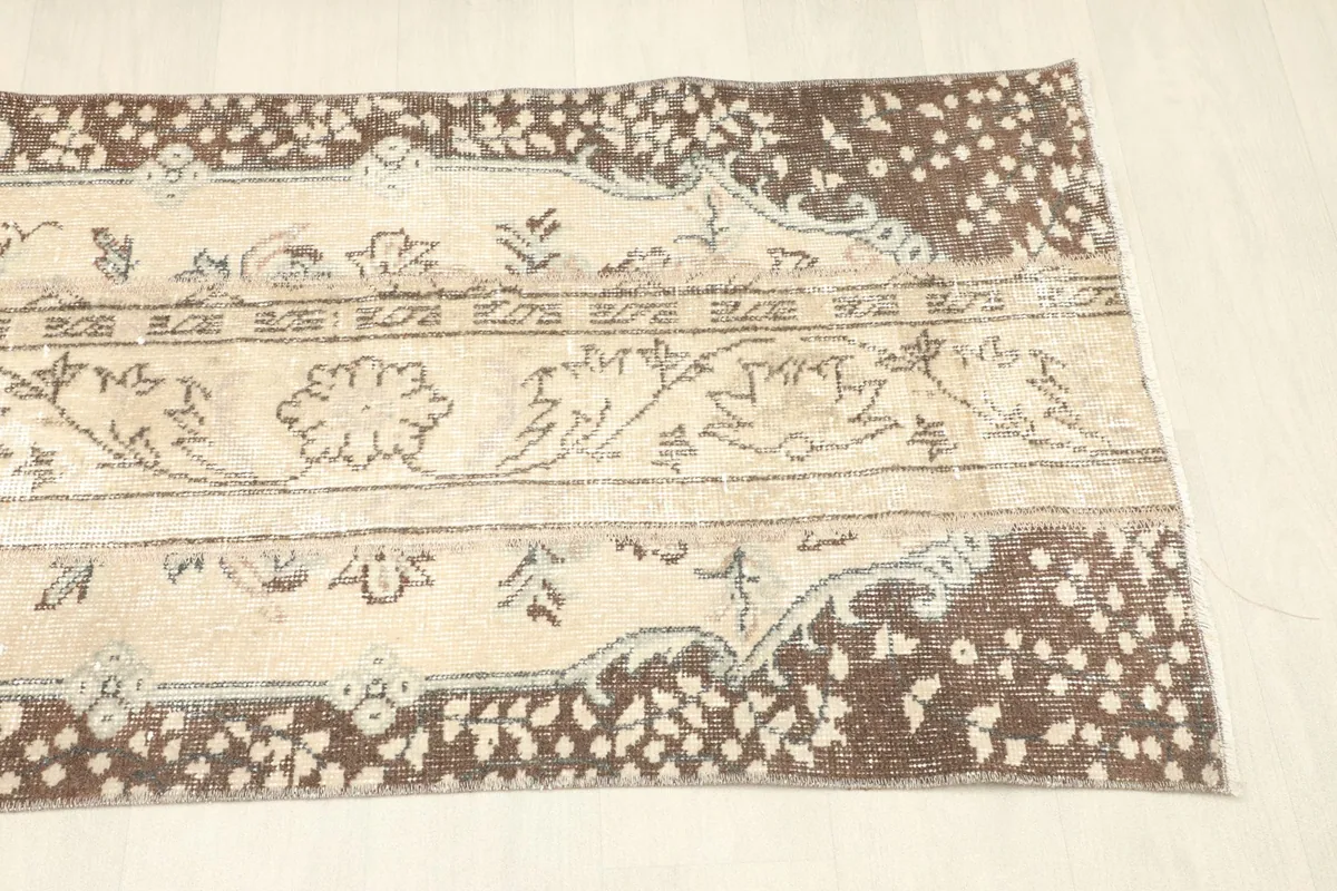 Angled view of the opposite end of the rug, detailing the hand-knotted wool pile and design elements.