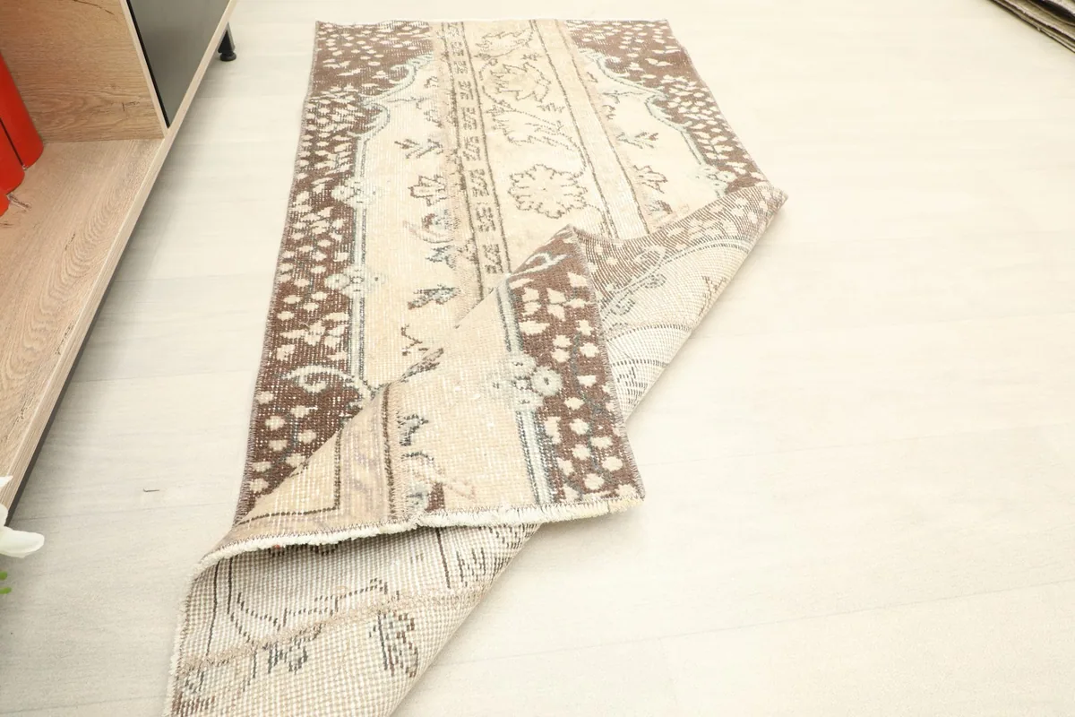 Another view of the rug with a folded corner, showing its flexibility and construction.