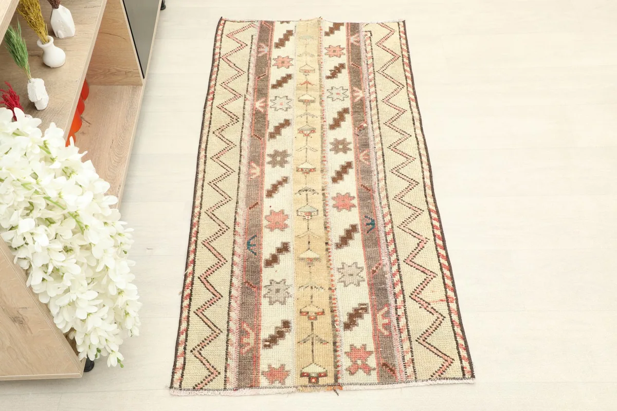 Overhead view of the hand-knotted wool rug, highlighting its striped geometric patterns.