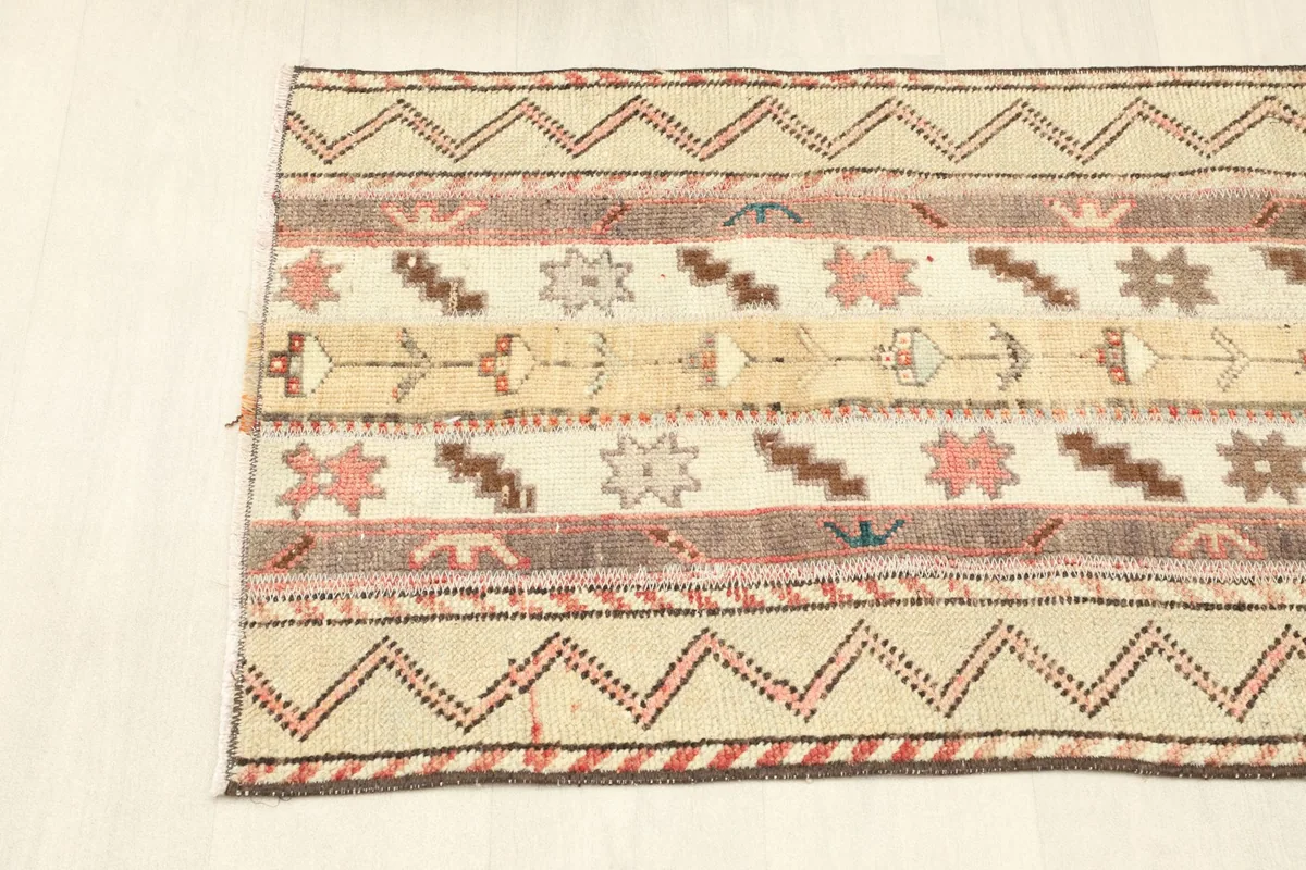 Overhead shot of one end of the rug, showing the alternating striped patterns and borders.