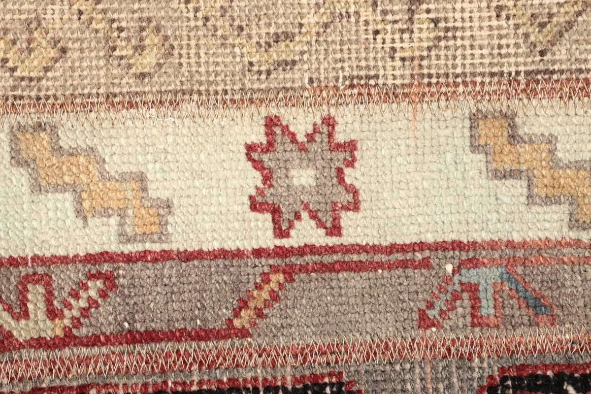 Detailed view of a geometric star motif and the low pile texture