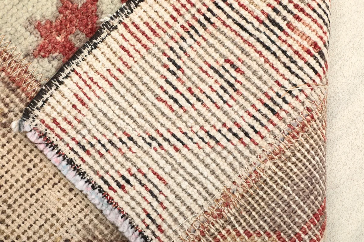 Backside of the rug, revealing the tightly woven cotton foundation and hand-knotted construction