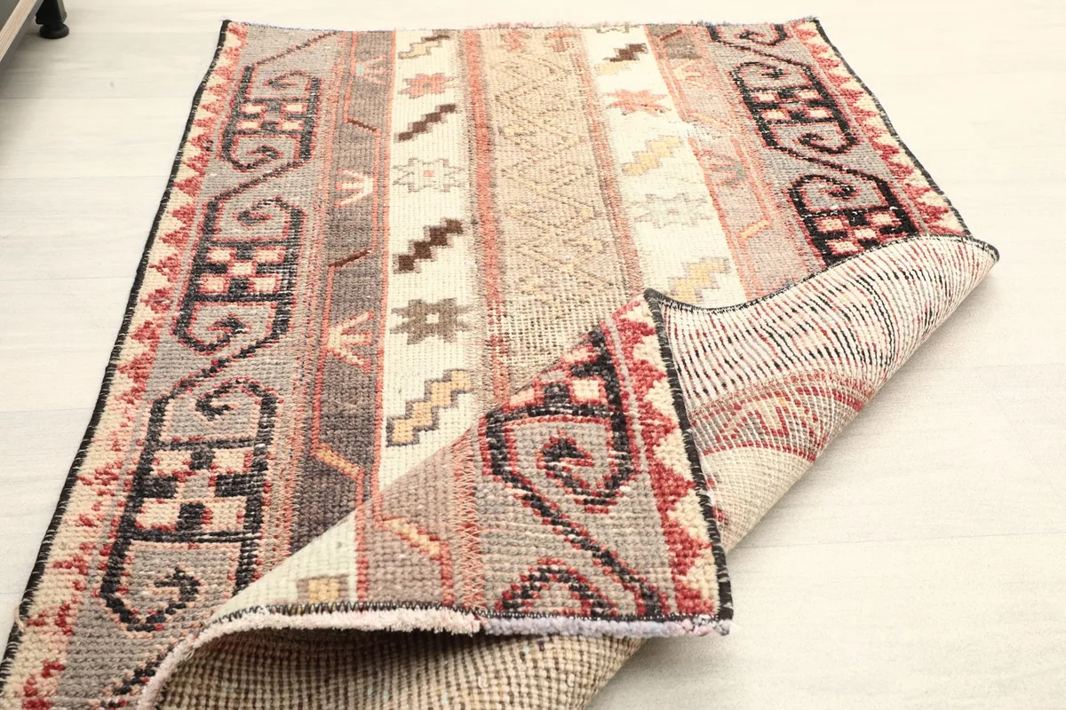 Rug partially folded, illustrating its flexibility and material thickness