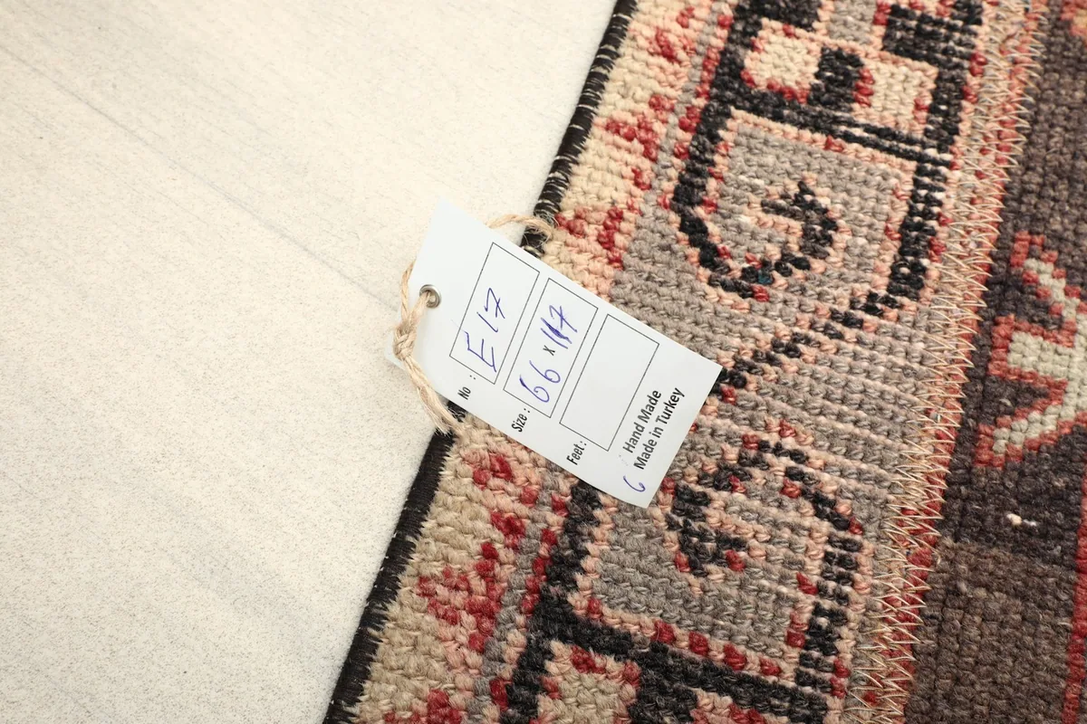 Close-up of the rug with a size tag showing measurements and origin