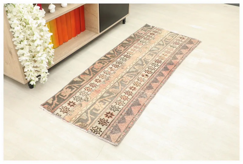Full overhead view of the vintage gray and rose striped Anatolian runner rug