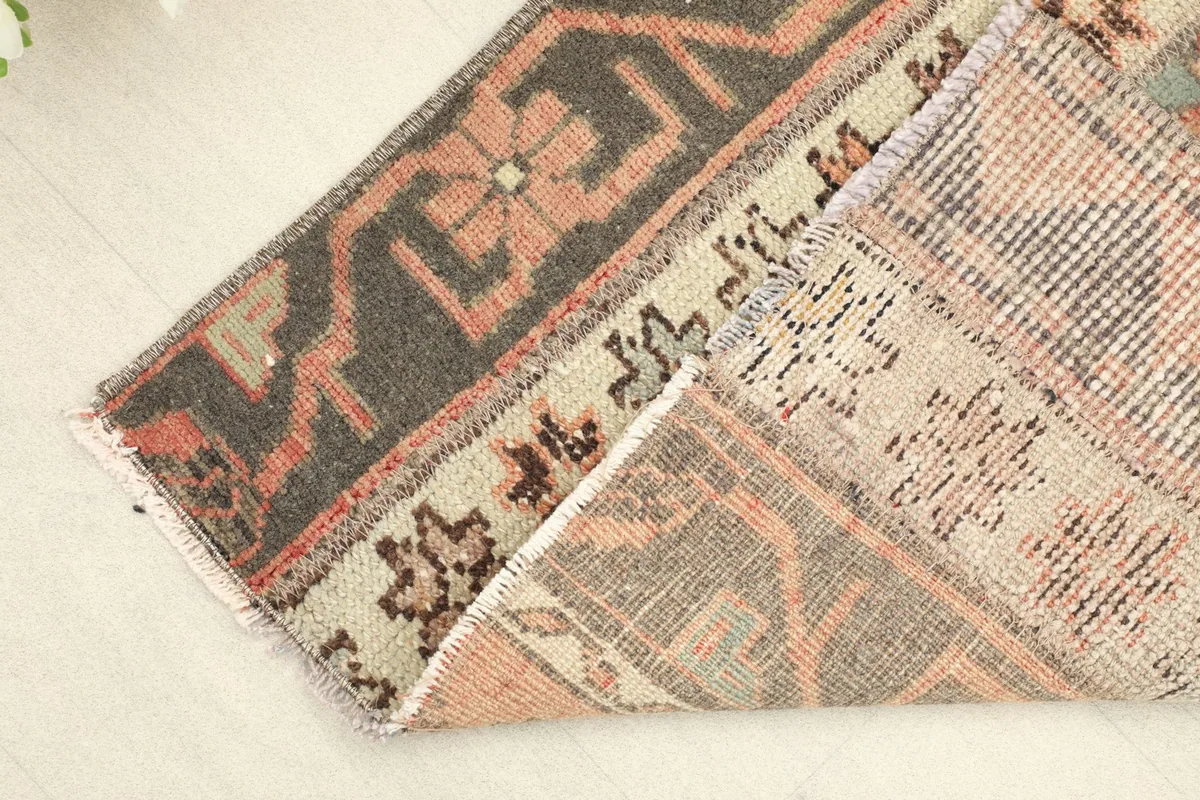 Corner folded back to reveal the hand-knotted cotton foundation and wool pile
