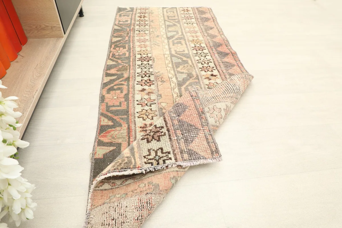 Rug partially folded, demonstrating its flexibility and texture