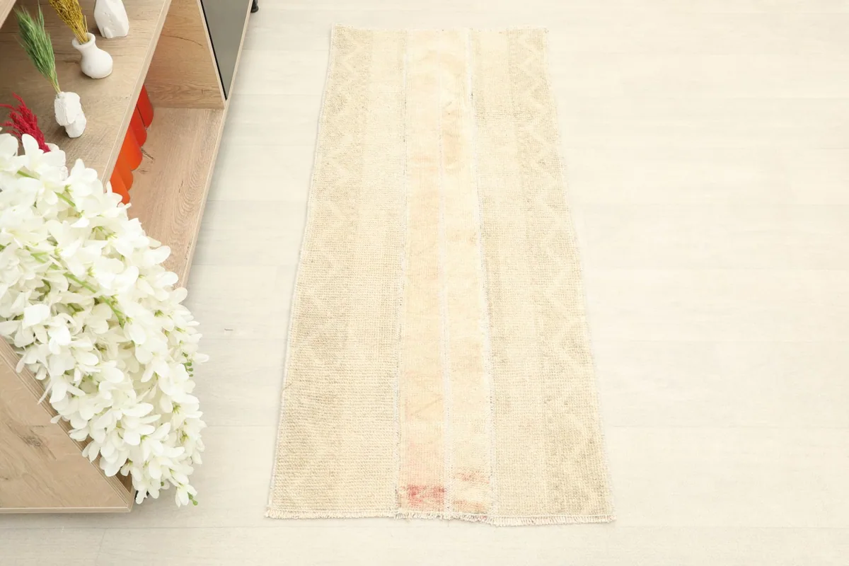 Overhead view of the vintage Anatolian rug, showing its rectangular shape and color variations.