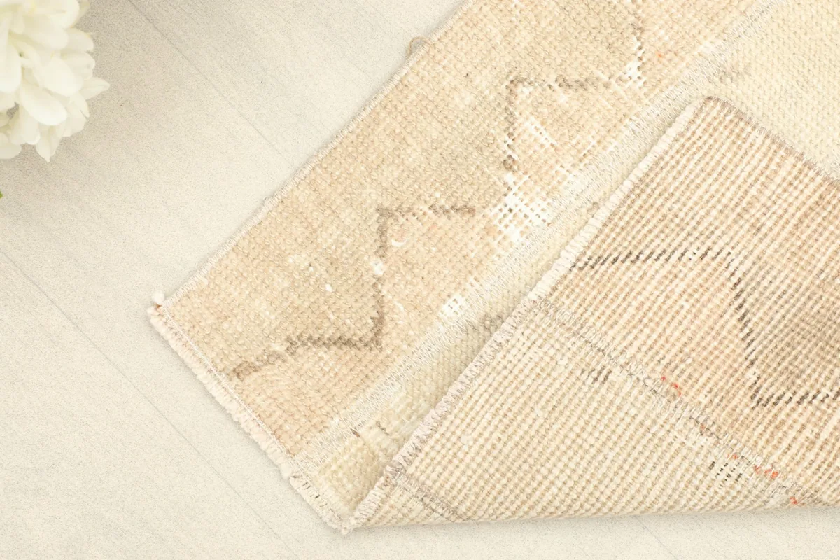 Flipped corner showing the back of the rug, revealing the cotton foundation and fine hand-knotting.