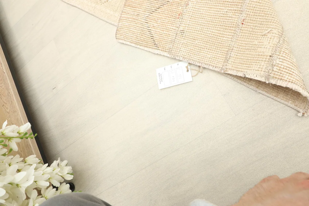 View of the rug's label and the tight weave on the reverse side, confirming its authenticity.