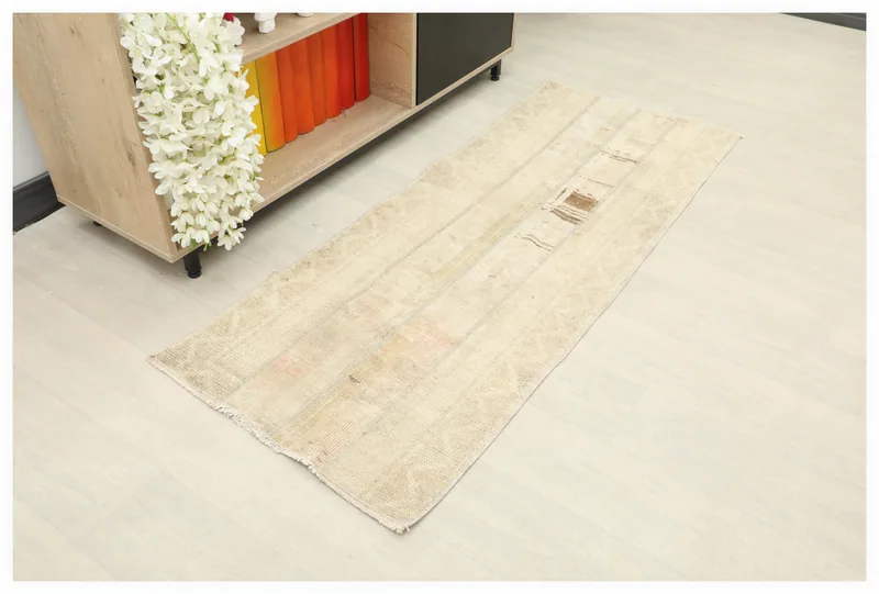 Full top view of the beige vintage Anatolian runner rug on a white background