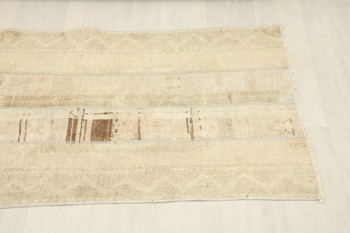 Angled view of the runner's length, emphasizing the beige field and subtle design elements
