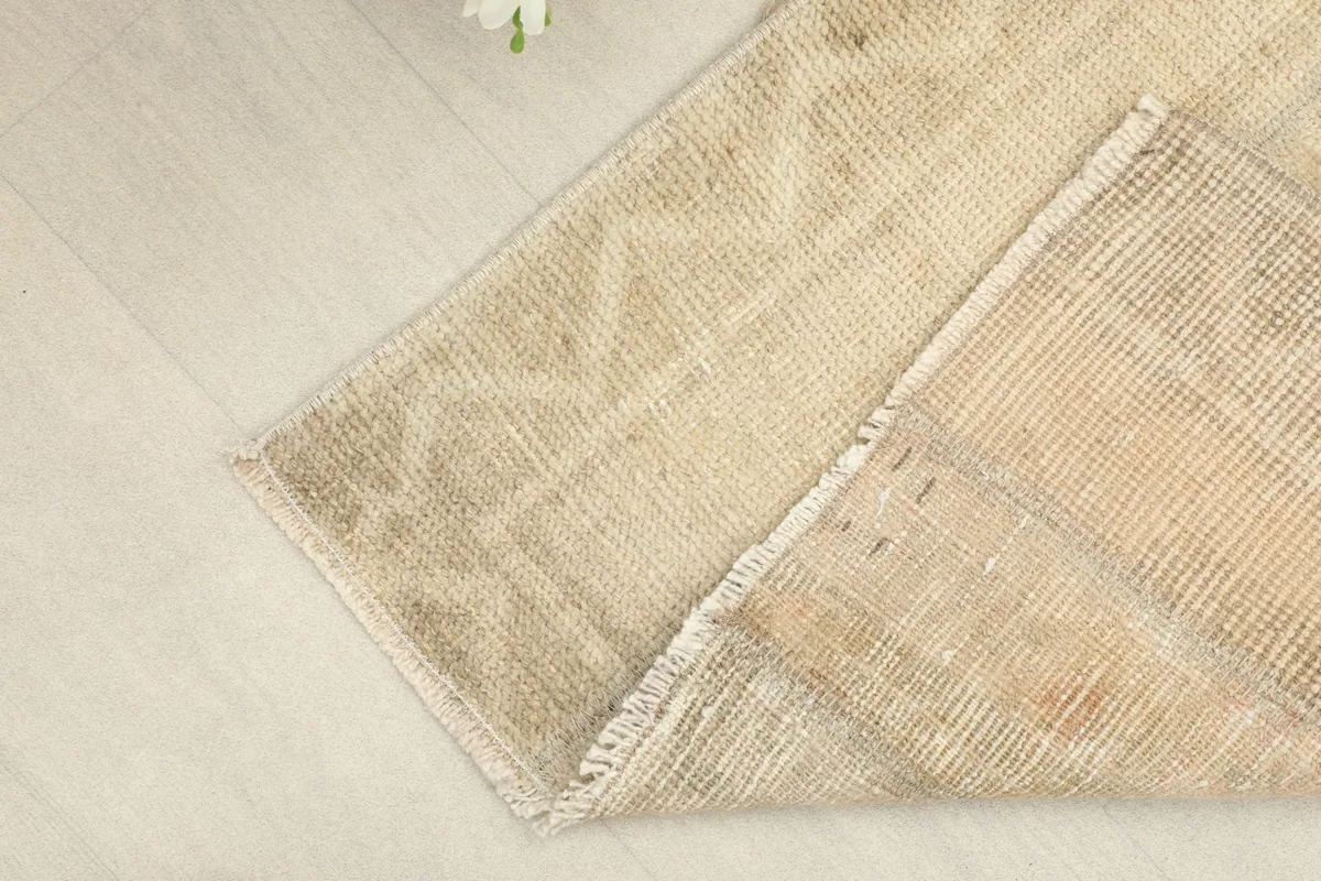 View of the rug's underside, revealing the hand-knotted cotton foundation