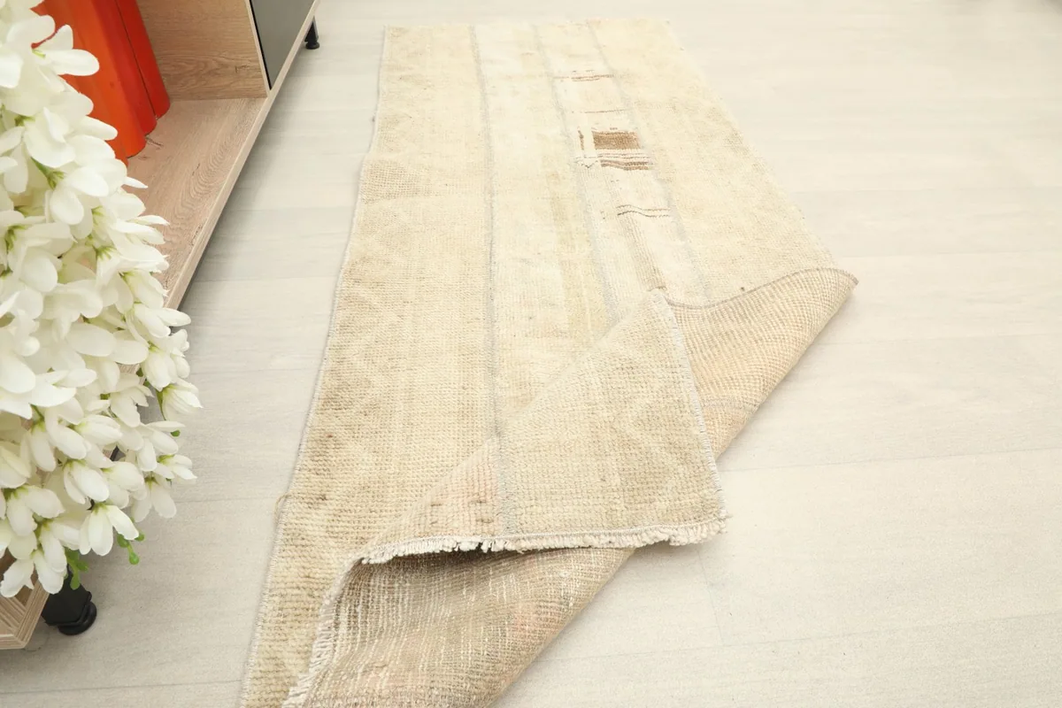 The runner rug partially folded, showing the pile and construction from an angle