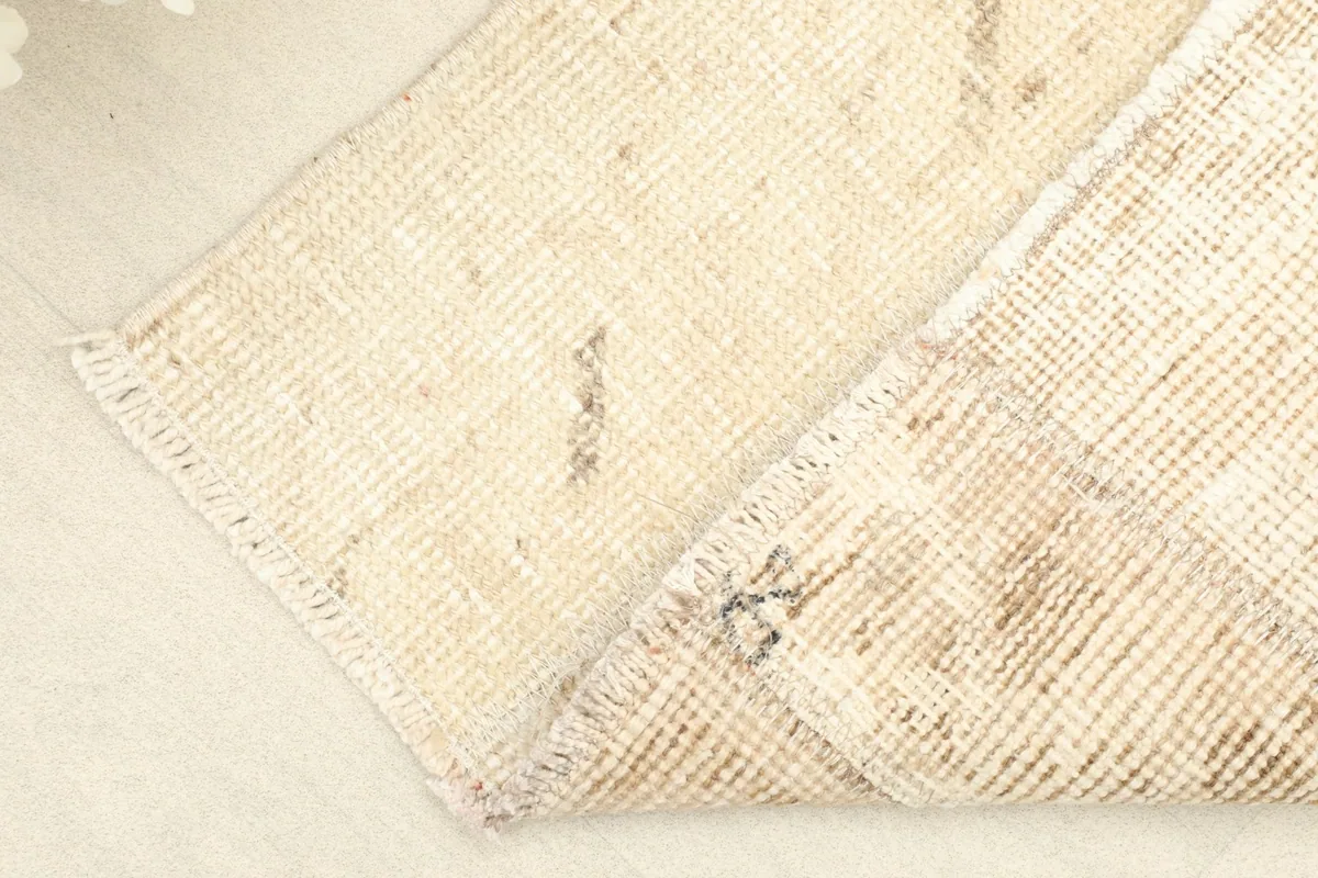 View of the back of the rug, revealing the cotton foundation and hand-knotted construction.