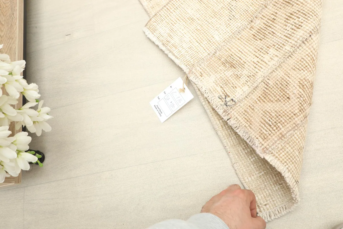 Close-up of the rug's label attached to the back, indicating its origin and materials.
