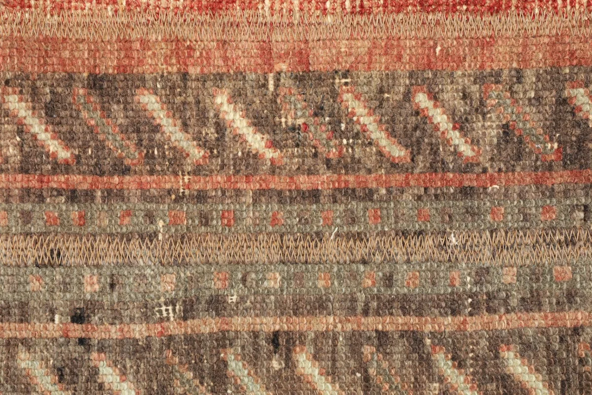 Detailed view of the central striped pattern, revealing fine hand-knotted texture and color blends.
