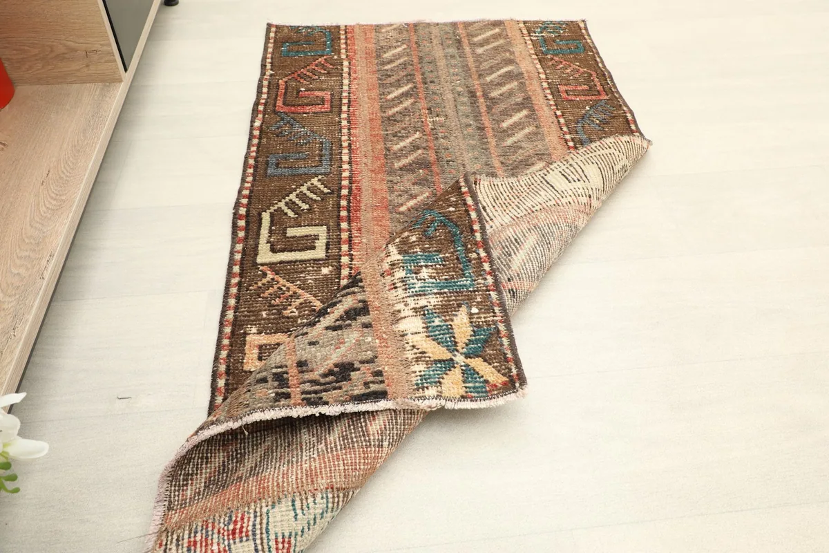 The rug partially folded, illustrating its flexibility and showing both top and back textures.