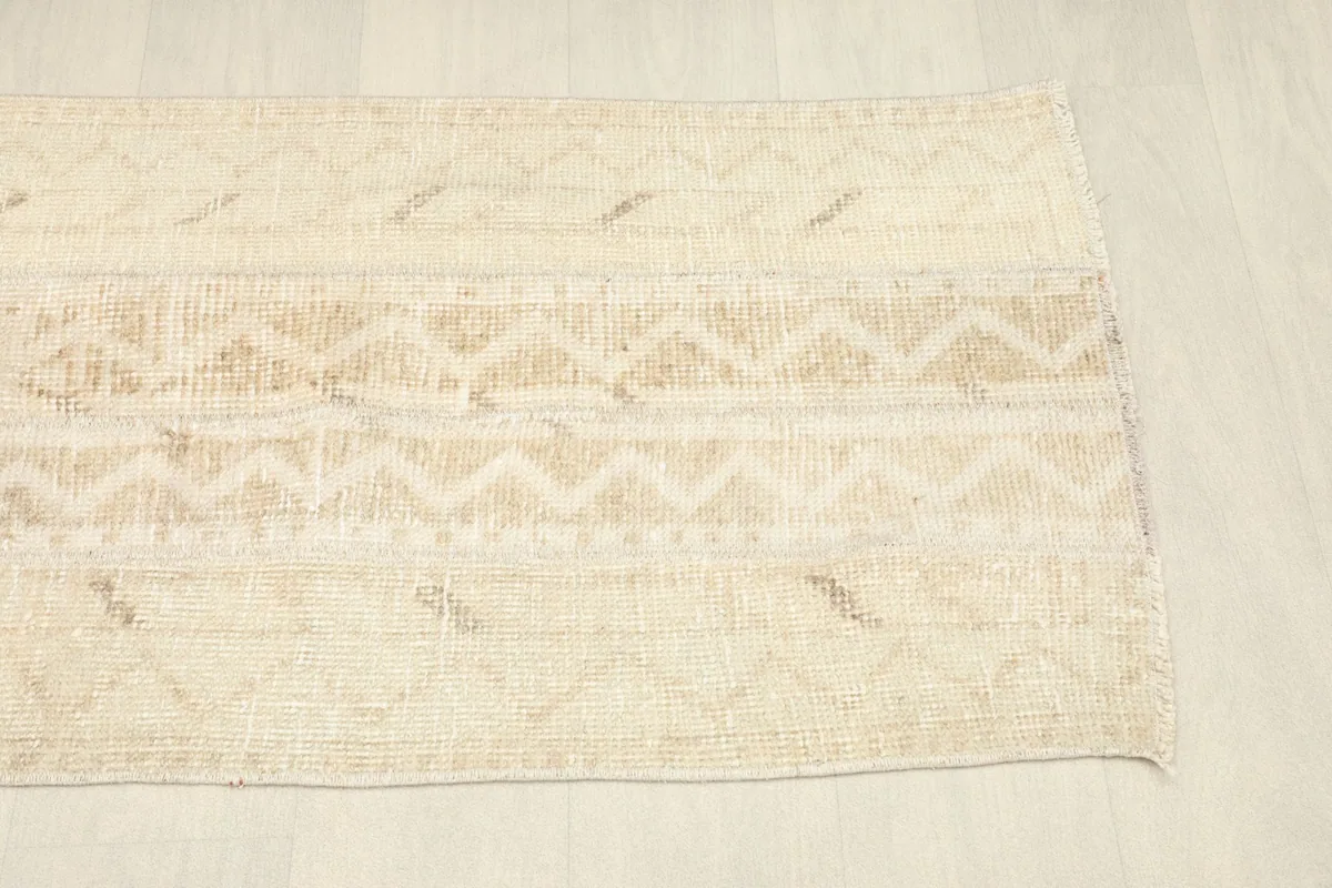 Another angled view of the vintage area rug, emphasizing the soft color transitions and tribal design.