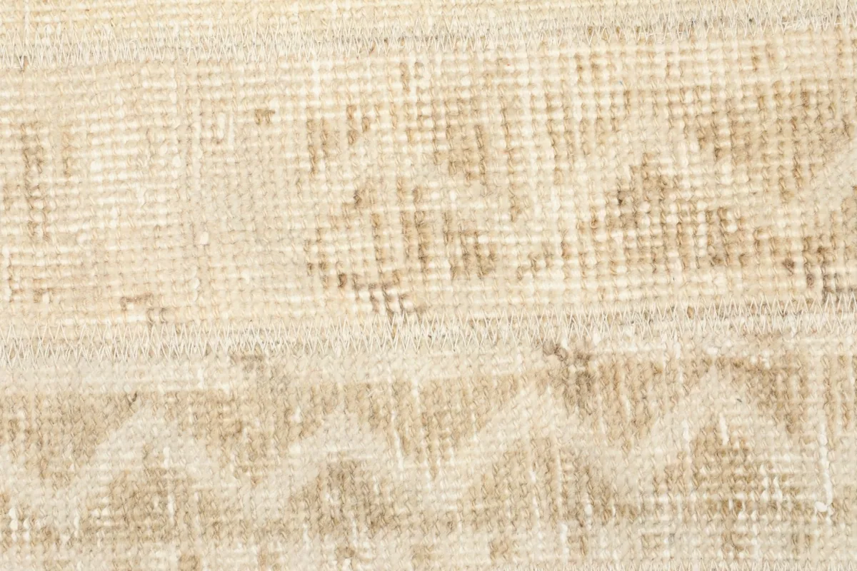 Detailed view of the low wool pile, showing the individual knots and variations in color.