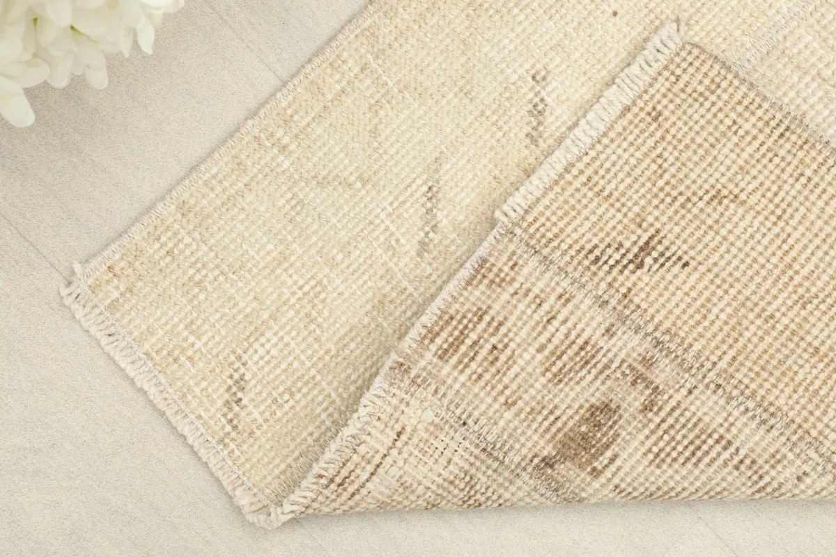 View of the back of the rug, showing the hand-knotted construction and cotton foundation.