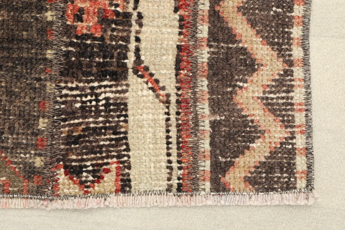 Close-up detail of the rug's edge, showing the hand-knotted texture and fringe
