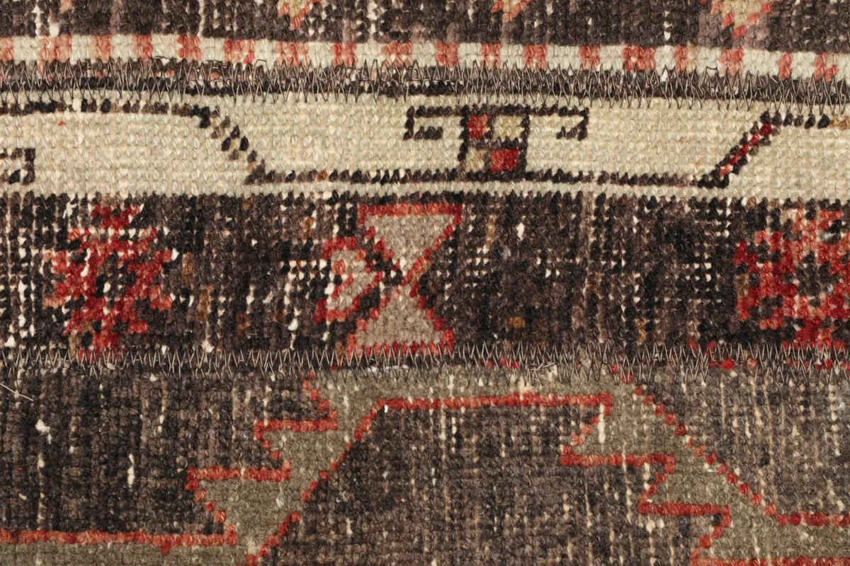 Detailed view of the rug's central design, showing individual knots and wool pile
