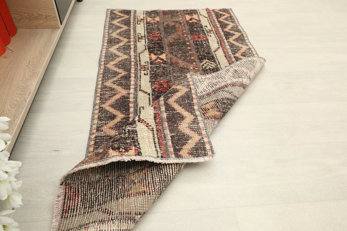 The rug partially folded, demonstrating its flexibility and construction