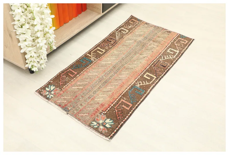 Full top view of the 1'11" x 3'10" brown and beige geometric Anatolian rug on a white background.