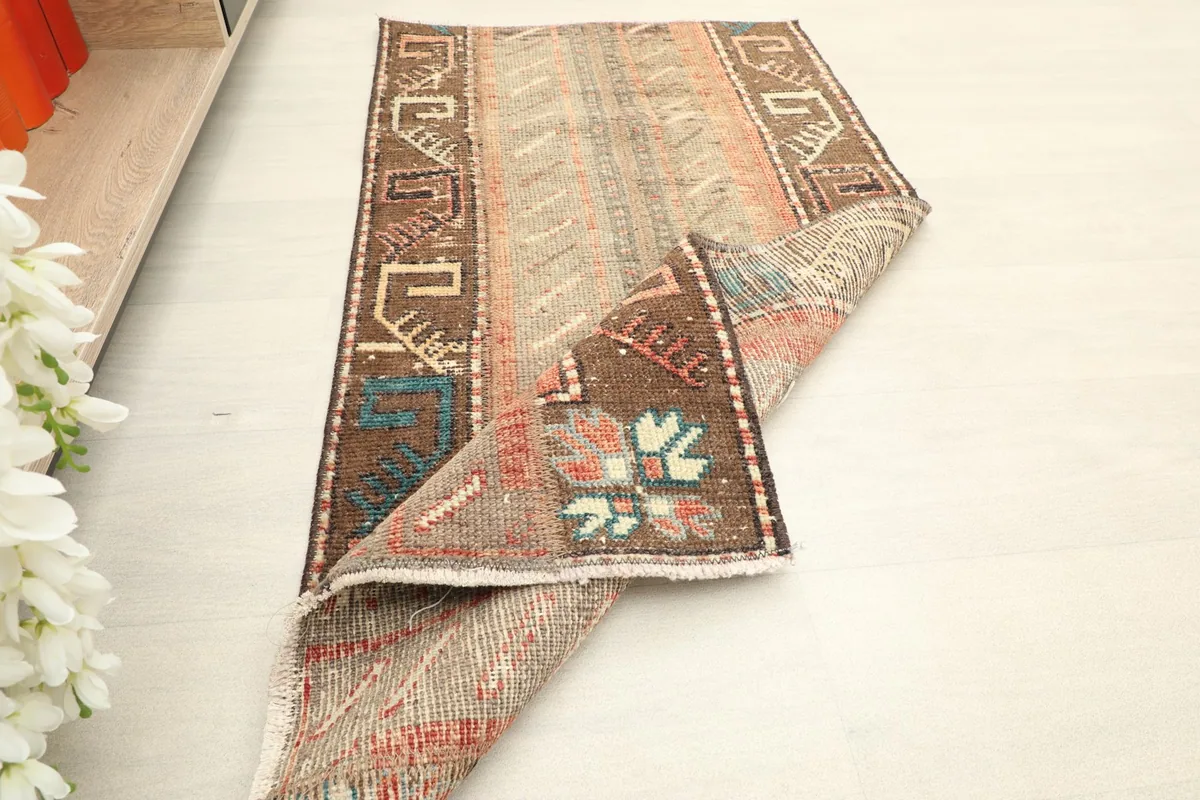 The rug partially folded, displaying both the front and back textures and the overall design.