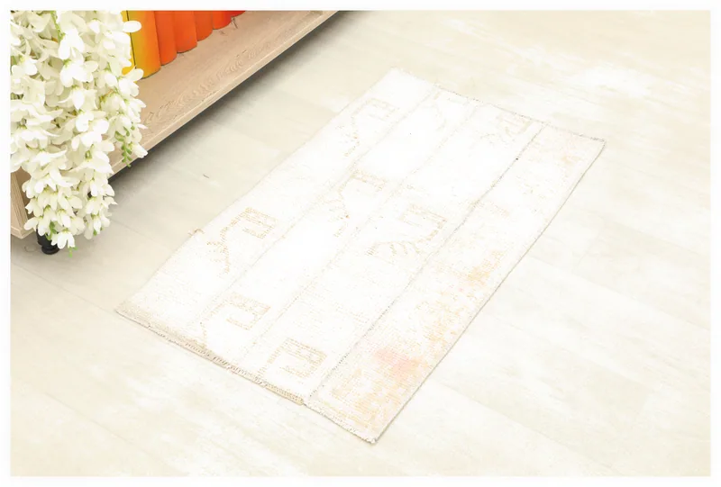 Full top view of the 1'7" x 2'9" ivory and beige geometric vintage Anatolian rug on a white background.