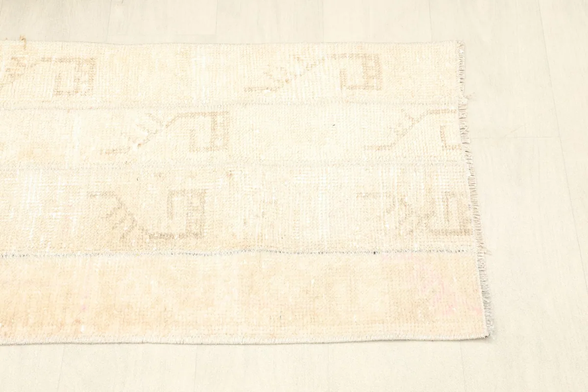View of the other end of the rug, detailing the subtle color variations and wear.