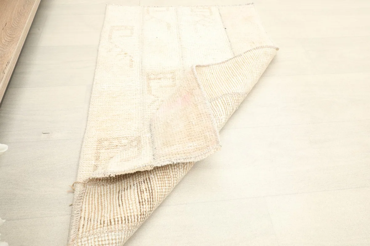 Rug corner folded over, illustrating its flexibility and the thickness of the material.