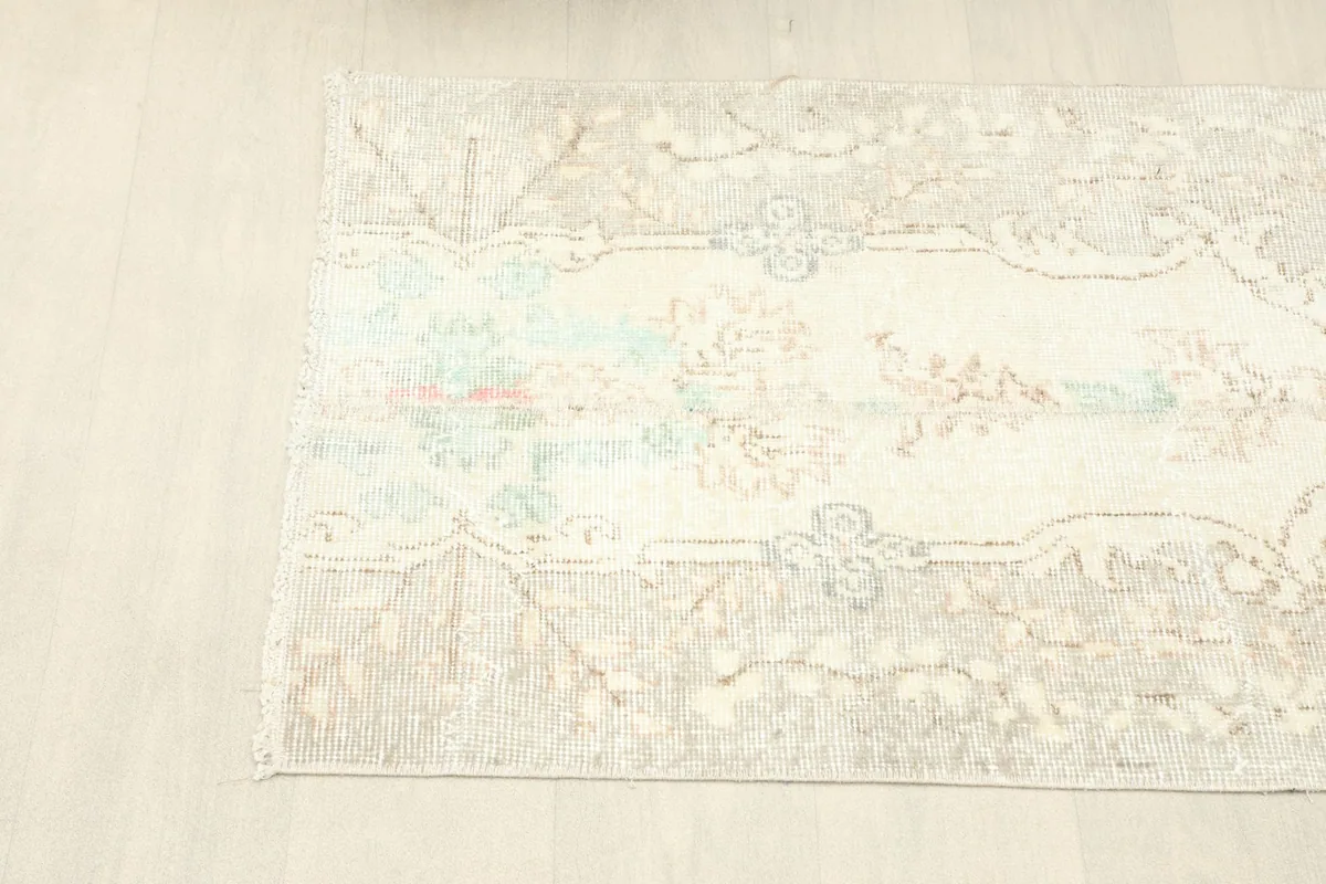 Angled view of the rug's length, showing the border design and overall shape.