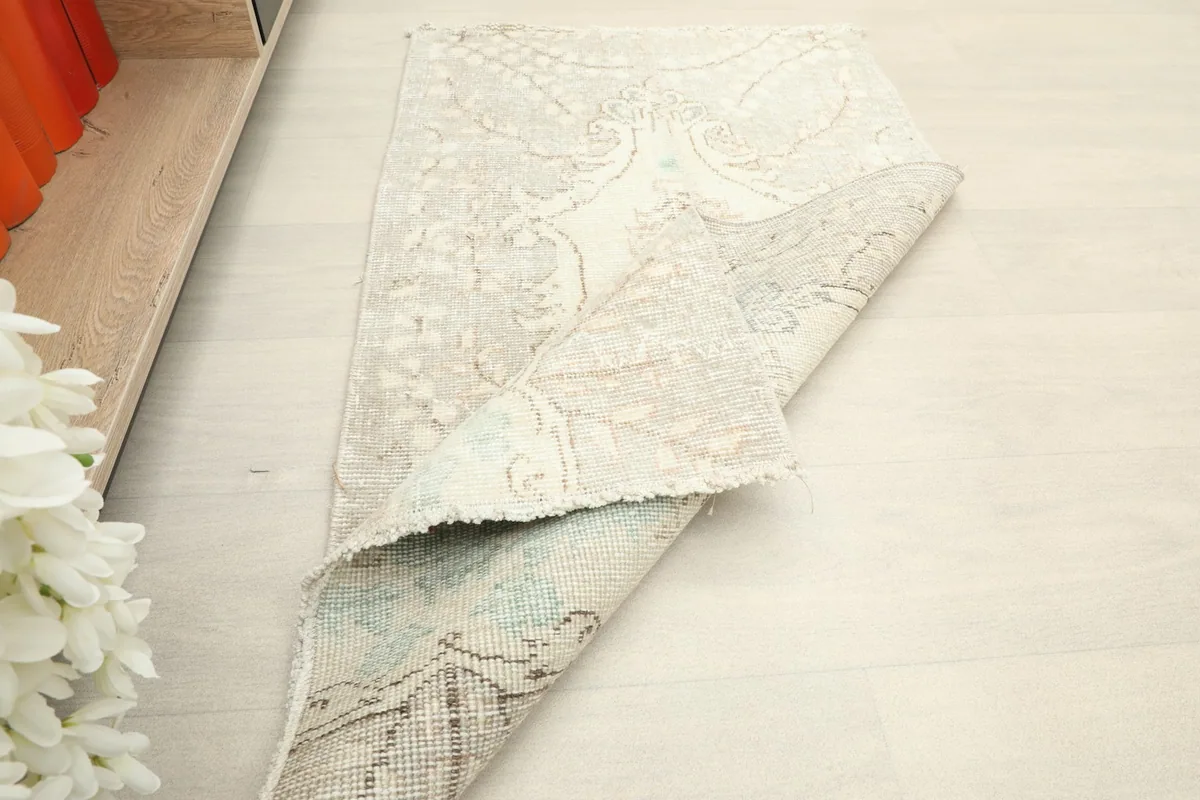 Rug partially folded, displaying both the front design and the reverse side.