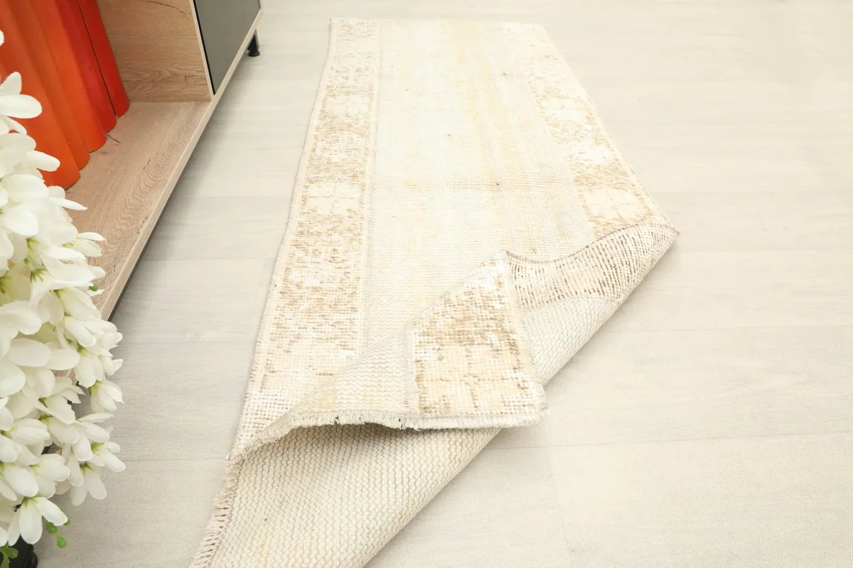 The runner rug folded to show its flexibility and the contrast between the front and back.