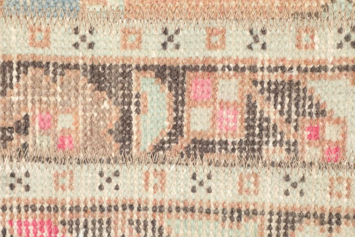 Detailed close-up of a central motif within the rug, revealing individual knots and color variations.
