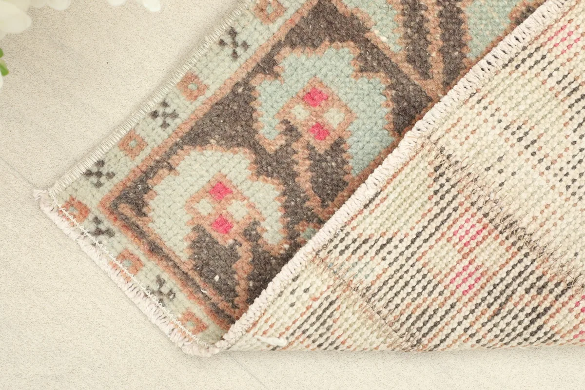Close-up showing the low wool pile and the hand-knotted construction of the vintage rug.