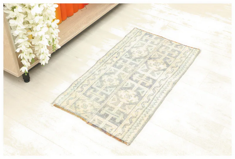 Full overhead view of blue and ivory geometric vintage rug