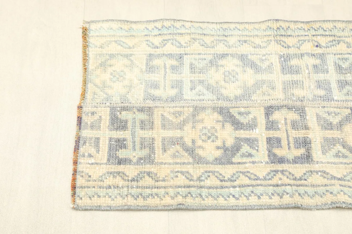Angled view showing one end of the rug with its border details
