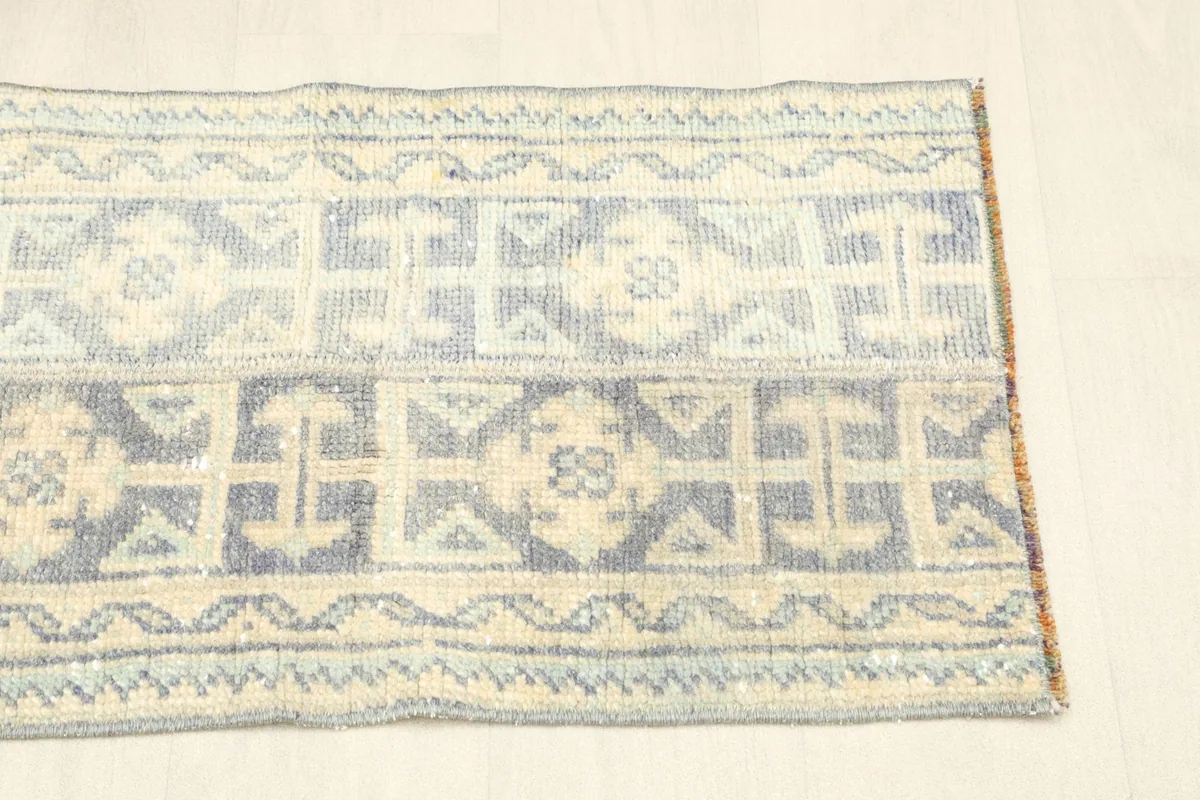Angled view showing the full length and width of the vintage rug